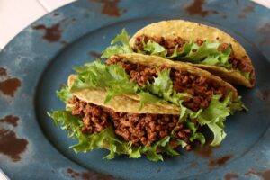 Ground beef taco on a ceramic plate