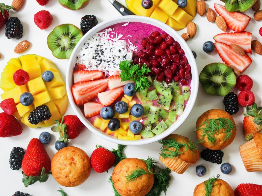 Assorted Sliced Fruits in White Ceramic Bowl.
